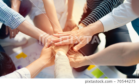Background of diversity human bare hands join together in the middle under with warm natural sun light, Concept power of social network or volunteer's to be unity help and support the network society. 70544275