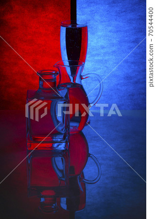 Still life with glass objects on a colored background 70544400