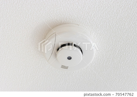 Fire alarm on the ceiling of a new house 70547762