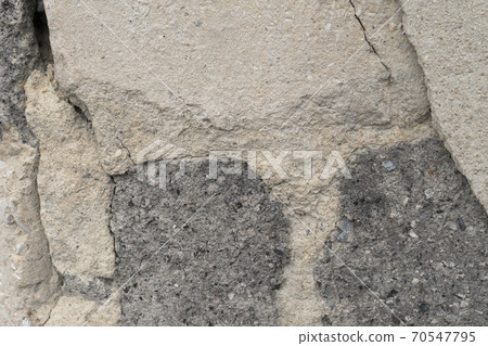 Old ruined gray wall of bricks and cement plaster. The concept of breaking down fundamentals over time Old ruined gray wall of bricks and cement plaster. The concept of breaking down fundamentals over time 70547795