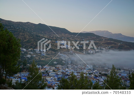 Blue city with morning mist_Old town of Chefchaouen (Morocco) Blue city with morning mist_Old town of Chefchaouen (Morocco) 70548333