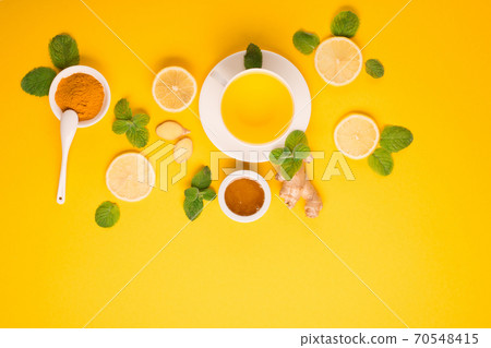 Lemon and ginger tea with honey on paper background. 70548415
