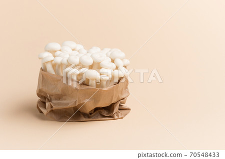 White beech mushrooms or Shimeji mushroom on pastel beige paper background. 70548433