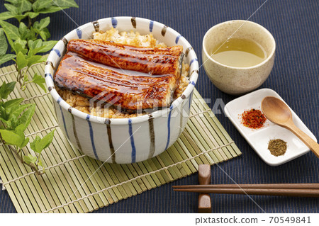 Unadon and Japanese tea placed on a bamboo mat 70549841