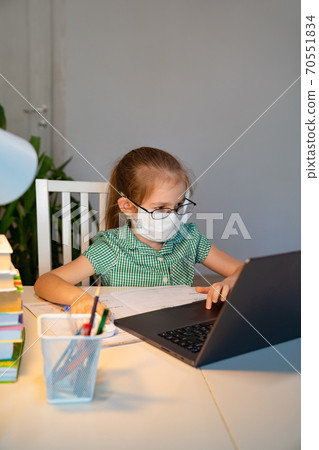 kid in glasses and mask study distant on laptop kid in glasses and mask study distant on laptop 70551834