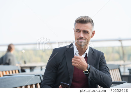 Looking amazing as man. Business man sit in outdoor Looking amazing as man. Business man sit in outdoor 70552428