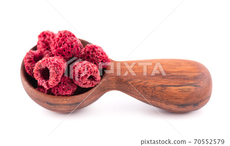 Dried raspberry isolated on white background. Dehydrated raspberry in wooden spoon. Dried raspberry isolated on white background. Dehydrated raspberry in wooden spoon. 70552579