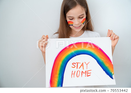 teen drew rainbow and poster stay home.  70553442
