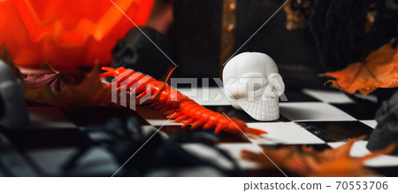 Halloween sculls on chess board and in chest. Spooky 70553706
