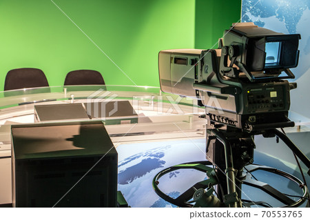 TV studio with professional camera aiming at empty seat, TV news studio with camera. 70553765
