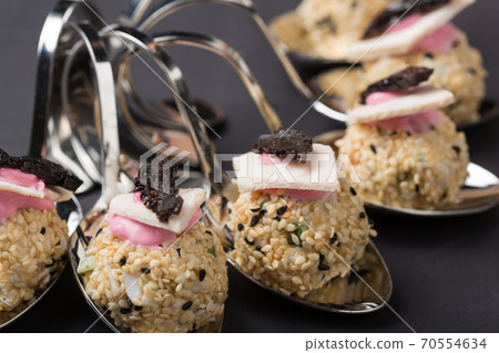delicious salad, cold appetizer is laid out on curly spoons delicious salad, cold appetizer is laid out on curly spoons 70554634