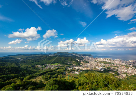 Ishikari Bay and the blue sky in the background in the city of Otaru seen from the observation deck of Mt. Tengu 70554833