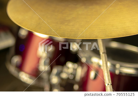 Crash plate with faded and red toms of a red drumset on background 70555125