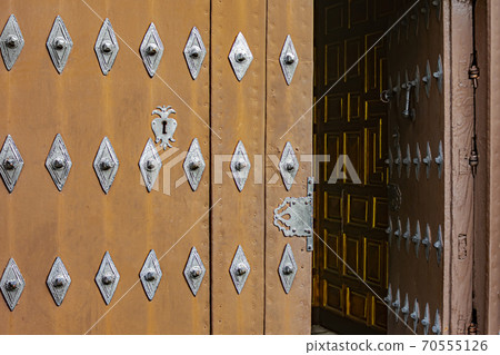 Entrance door to a church made with wood and metal elements 70555126