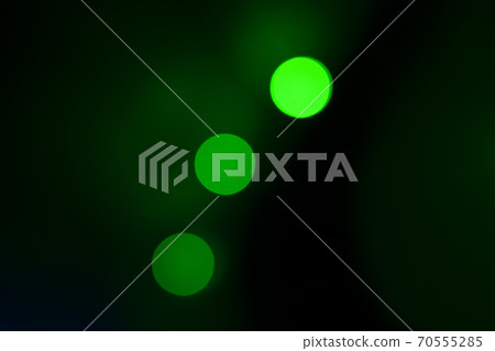 Flashes of colored lights on black background Flashes of colored lights on black background 70555285