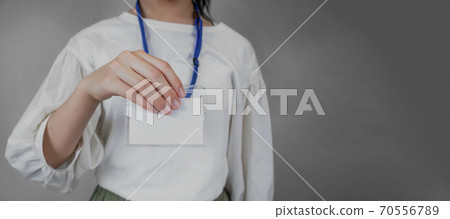 Woman showing a blank ID card Woman showing a blank ID card 70556789