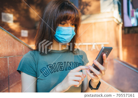 Young woman wearing medical face mask 70557161