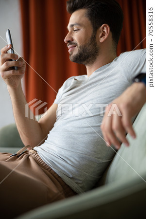 Handsome man using mobile phone 70558316
