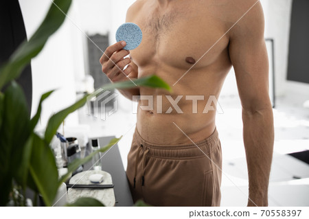 Cropped shot of handsome man holding cotton pad 70558397
