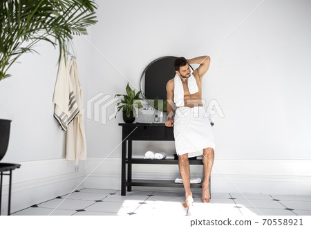 Portrait of bearded man with towel on his neck Portrait of bearded man with towel on his neck 70558921