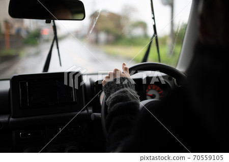 Inside a car driving a car on a rainy day 70559105