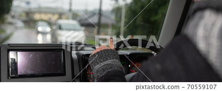 Inside a car driving a car on a rainy day 70559107