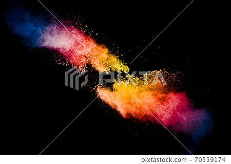Freeze motion of colorful dust particles splash. Painted Holi powder. 70559174
