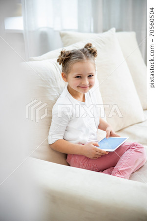 Girl using a tablet Girl using a tablet 70560504