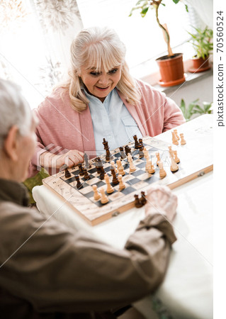 Woman looking at the chessboard with wonder 70560524