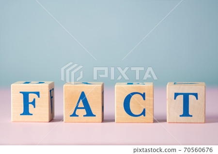Wooden cubes with blue letters with word fact on pink and gray background with free space for text. False and real fact and concept of news. Statement of reality or what is happening. Wooden cubes with blue letters with word fact on pink and gray background with free space for text. False and real fact and concept of news. Statement of reality or what is happening. 70560676