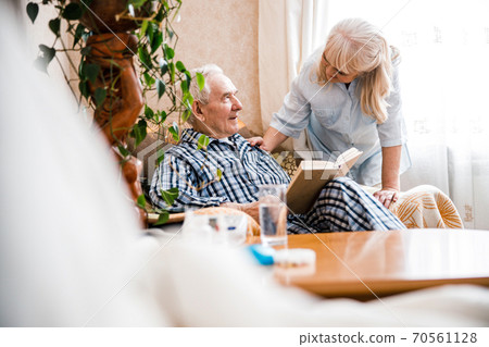 Seniors reading a book together Seniors reading a book together 70561128