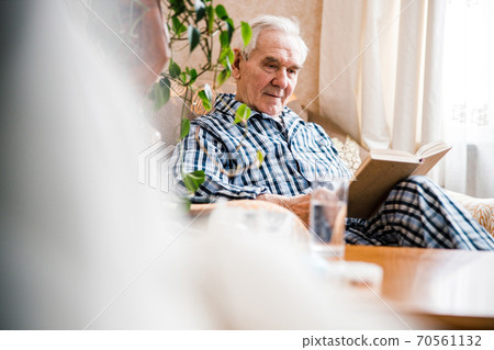 Mature man reading book 70561132
