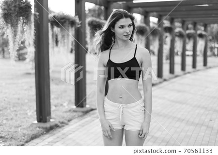 Portrait of a beautiful young sporty brunette girl. Black and white photo. BW 70561133