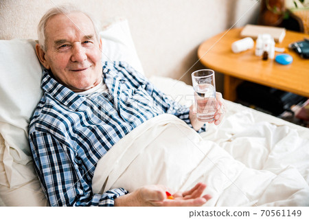 Mature man with supplements pill 70561149