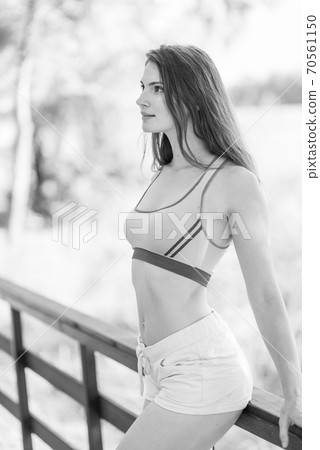 Portrait of a beautiful young sporty brunette girl. Black and white photo. BW 70561150