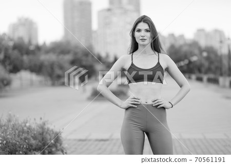 Portrait of a beautiful young sporty brunette girl. Black and white photo. BW 70561191