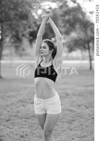 Portrait of a beautiful young sporty brunette girl. Black and white photo. BW Portrait of a beautiful young sporty brunette girl. Black and white photo. BW 70561418