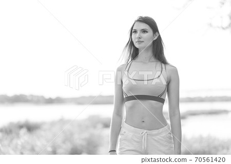 Portrait of a beautiful young sporty brunette girl. Black and white photo. BW Portrait of a beautiful young sporty brunette girl. Black and white photo. BW 70561420