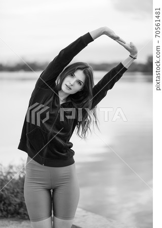 Sports and healthy lifestyle : Brunette girl doing sports exercises. Black and white photo. BW 70561481