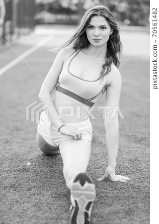 Sports and healthy lifestyle : Brunette girl doing sports exercises. Black and white photo. BW Sports and healthy lifestyle : Brunette girl doing sports exercises. Black and white photo. BW 70561482