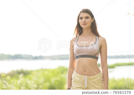 Portrait of a beautiful young sporty brunette girl 70561579