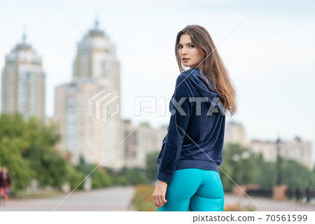 Portrait of a beautiful young sporty brunette girl Portrait of a beautiful young sporty brunette girl 70561599