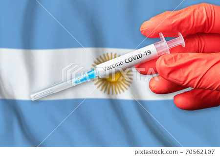 Coronavirus COVID-19 vaccination concept in Argentina with doctor hand and syringe 70562107