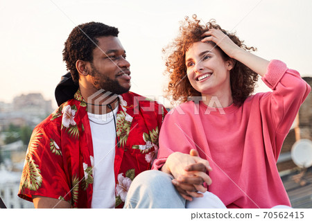 Joyful couple in love during summer evening Joyful couple in love during summer evening 70562415