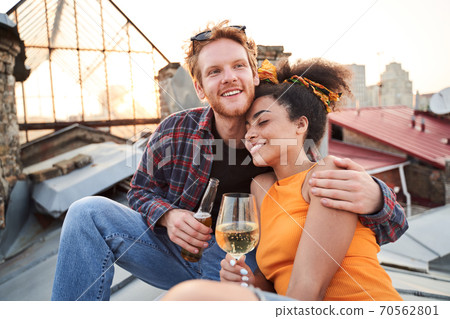 Blessed young couple meeting sunset with drinks Blessed young couple meeting sunset with drinks 70562801
