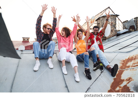 Jolly four people having fun on urban roof Jolly four people having fun on urban roof 70562818