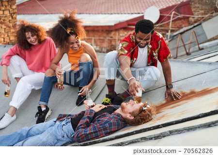 Happy friends having fun together on roof Happy friends having fun together on roof 70562826