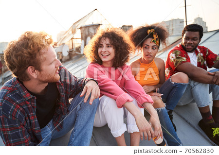 Two happy couples meeting sunset on roof Two happy couples meeting sunset on roof 70562830