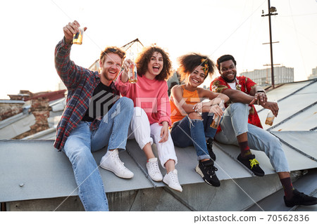 Happy four people celebrating on urban roof Happy four people celebrating on urban roof 70562836