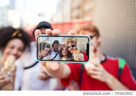 Jolly friends taking photo for cathing memories together Jolly friends taking photo for cathing memories together 70562902
